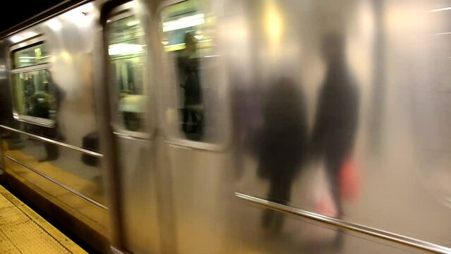 Close up of NYC subway train passing platform.