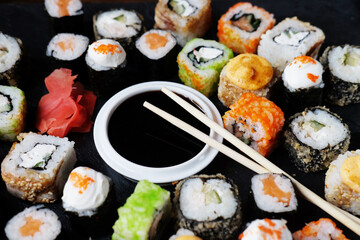 Set of sushi and maki on stone table. Flat lay, top view