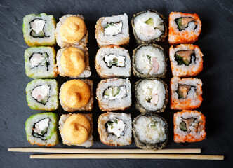 Set of sushi and maki on stone table. Flat lay, top view