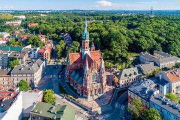 Krakow, Poland. Church Saint Joseph - a historic Roman Catholic church in Gothic Revival (neo-Gothic) style at the Podgorski Square in Podgorze district in Cracow in sunset light. Aerial view - 514447927