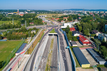 New highway in Krakow, called Trasa Łagiewnicka with multilane road with tunnels, junctions for cars and trams, to be opened in July 2022. Part of the ring road around Cracow city center. Aerial view