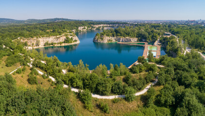 Kraków, Poland. Zakrzówek lake with steep cliffs in place of former flooded limestone quarry. Recreational place with swimming pools, restaurants and other facilities under construction. Aerial view