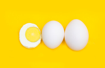 whole eggs and boil egg isolated on yellow background,top view