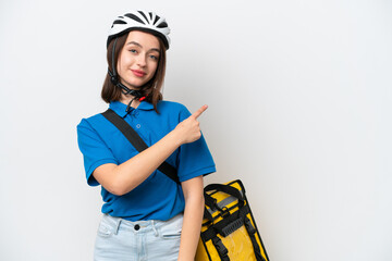 Young Ukrainian woman with thermal backpack isolated on white background pointing back