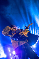 Fototapeta premium Person with a guitar performing in the concert