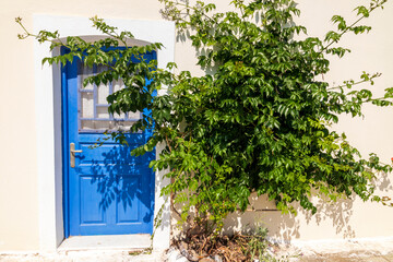 Naxos Greece 06-02-2022. Blue door and flower  at Melanes traditional village in Naxos. Greece.