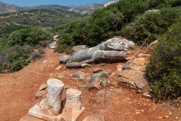 Naxos Greece 06-02-2022. 
Broken statue lying on the ground. Called Kouros.  at Melanes traditional village in Naxos. Greece.