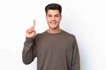 Naklejka premium Young handsome caucasian man isolated on white bakcground pointing up a great idea