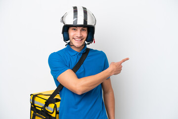 Young caucasian man with thermal backpack isolated on white background pointing back