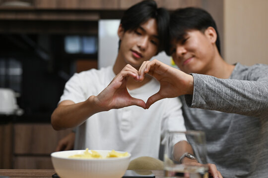 Selective focus on LGBT couple hands doing heart shape, LGBT pride month and LGBT couple concept.