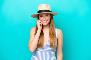 Fototapeta premium Young woman isolated on blue background happy in swimsuit in summer holidays