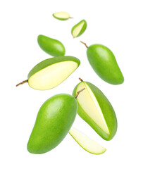 Green mango with cut in half sliced flying in the air isolated on white background. 