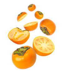 Persimmon fruit and cut in half sliced flying in the air isolated on white background. 