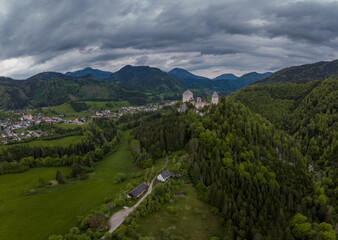 Fototapeta na wymiar Aerial drone view of castle Gallenstein, close to Sankt Gallen in Austria on a cloudy summer day. Green forest surrounding the ruins of a castle.