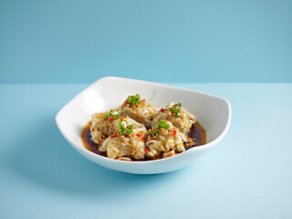 Pork Wanton in Chilli Vinaigrette with chopsticks served in a dish isolated on mat side view on grey background