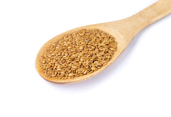 Golden linseed on a spoon isolated over white background