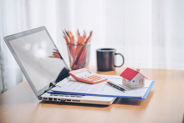 mortgage, investment, real estate and property concept - close up of home model, dollar money and house keys