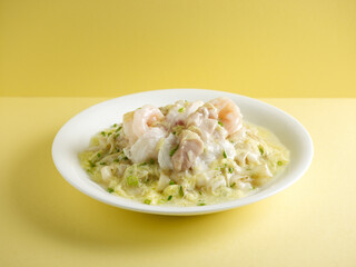 braised hor fun with seafood and scrambled egg with chopsticks served in a dish isolated on mat side view on grey background