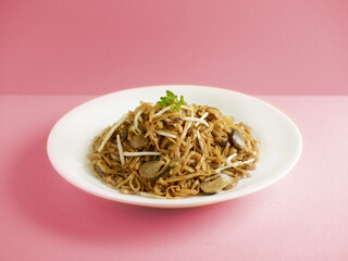 Stewed Ee-Fu Noodles with Assorted Seafood served in a dish isolated on cutting board side view on dark background