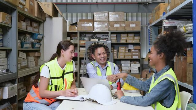 Warehouse manager congratulations to woman employees who have been appointed as supervisors.