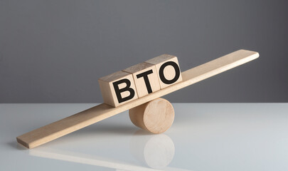 BTO Build to Order on wooden cubes on a wooden balance , business concept