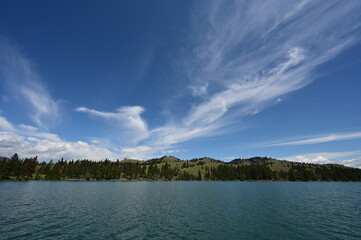 Beautiful dramatic summer cloudscape over Flathead Lake in Montana on calm June day.