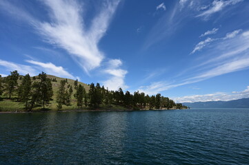 Beautiful dramatic summer cloudscape over Flathead Lake in Montana on calm June day.