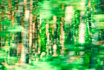 Abstract Green trees motion blurred green leaves background.