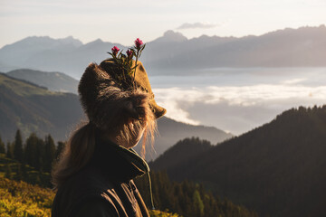 after the hunt - a huntress looks over a foggy valley to the alps at a sunny summer morning