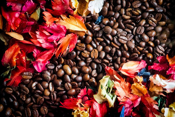 The background image is made of coffee beans decorated with flowers. background concept for coffee shop