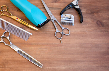 set of pets grooming tools on a wooden background