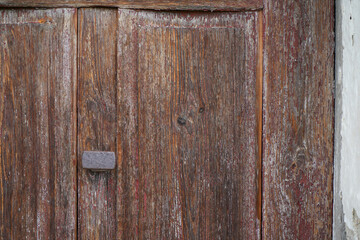 Wooden wall on an old house with a garden