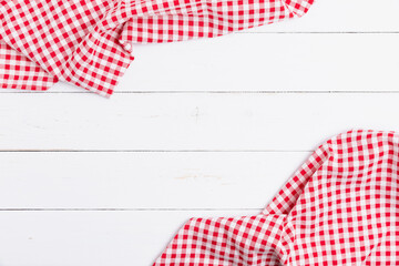 Backdrop for menu of food to restaurants. Red and white fabric tablecloth checkered on wooden white background with copy space. top view, flat lay.