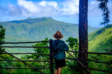 Fototapeta na wymiar Boy watching the scenery in Black River Gorge trail, Mauritius