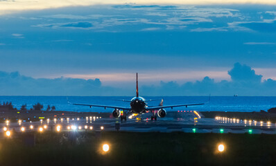 Airplane prepere for take off on runway with colour sky