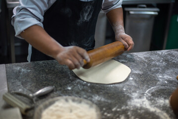 home bakery. Confectioner rolling gingerbread dough with rolling pin.People cooking food