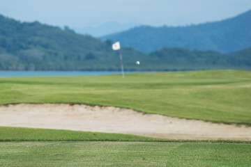 golf course and far green golf with blur flag of hole