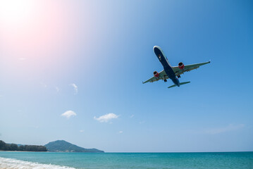 Fototapeta na wymiar Plane is landing over sea with beach in phuket