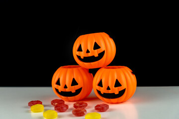 Three halloween pumpkins with candies