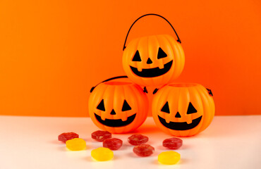 Fototapeta premium Three halloween pumpkins with candies