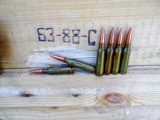 training cartridges for the Kalashnikov assault rifle, AK on the background of a wooden box
