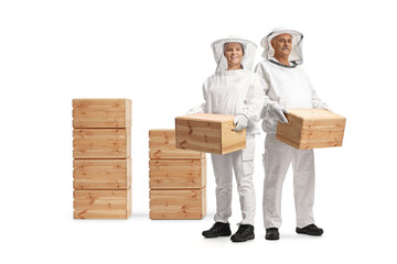 Male and female bee keepers in uniforms holding wooden crates
