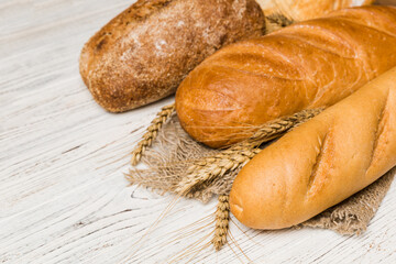 Homemade natural breads. Different kinds of fresh bread as background, perspective view with copy space