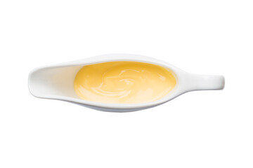 Creamy cheese sauce in the white sauceboat. cheese sauce isolated on white background. top view