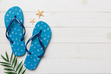 Flat lay composition with flip flops and seashell on colored background. Space for text top view