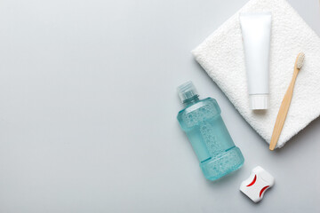 Mouthwash and other oral hygiene products on colored table top view with copy space. Flat lay. Dental hygiene. Oral care products and space for text on light background. concept