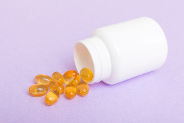 Omega-3 capsules lie in white bottle on a table background. Fish oil tablets top view. Biologically active additives. omega 6, omega 9, vitamin A, E, vitamin D, vitamin D3, evening primrose oil