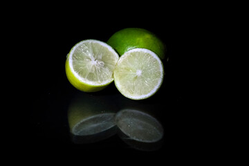 Yellow lemon slices isolated on black background macro close up reflection