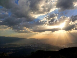 Sunset over the Sarajevo valley and mountains around, sun rays breaking through clouds, Bosnia and Herzegovina