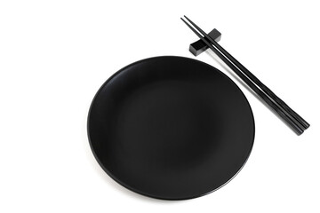 Black chopsticks and black plate on white